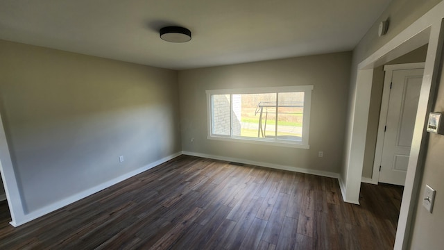 spare room featuring dark hardwood / wood-style floors