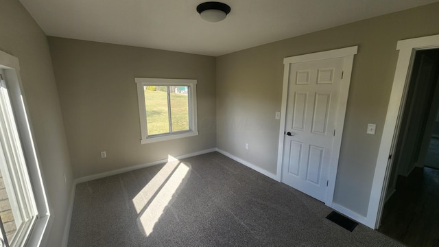 unfurnished bedroom featuring dark colored carpet