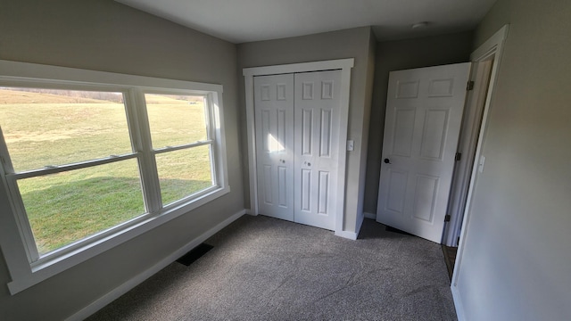 unfurnished bedroom with carpet floors and a closet