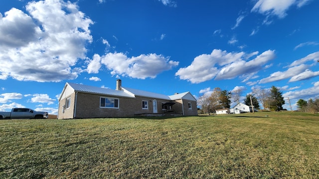 back of property featuring a lawn