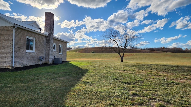 view of yard featuring cooling unit and a rural view