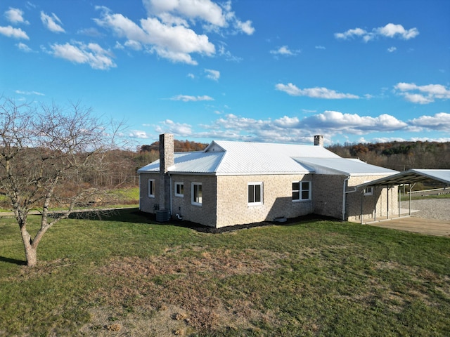 view of home's exterior with a yard and a patio