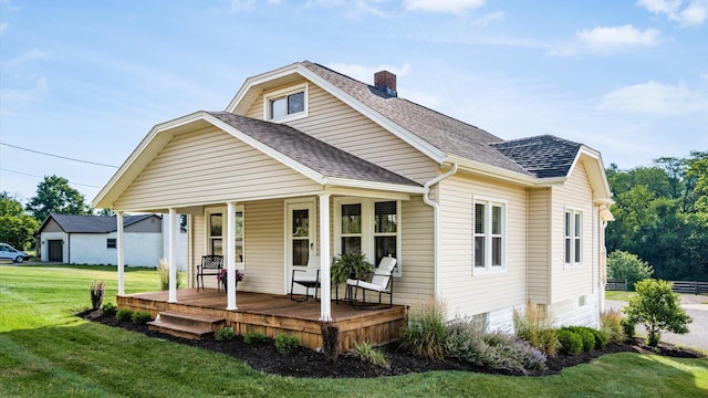 view of front facade with covered porch and a front yard