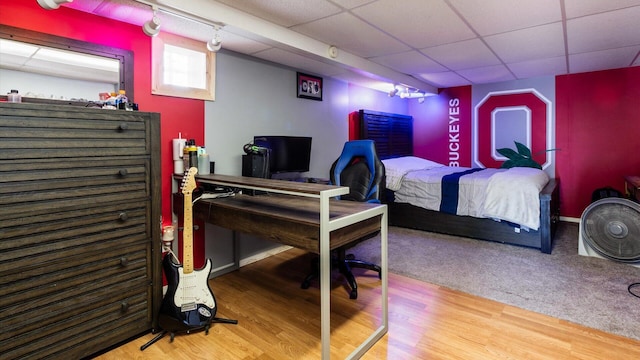 bedroom with hardwood / wood-style flooring and a drop ceiling