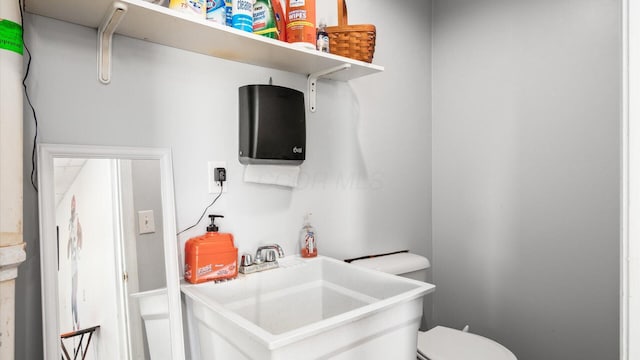 interior space featuring sink and toilet