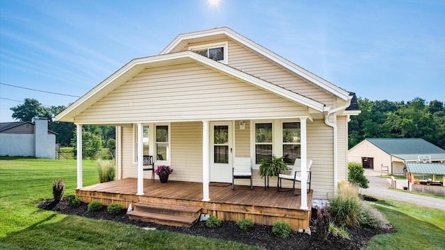 rear view of property with a yard and a porch