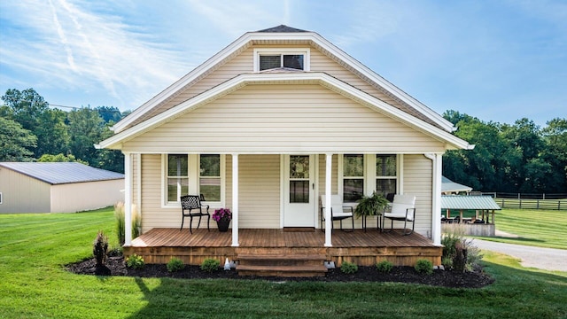 bungalow-style house with covered porch and a front yard