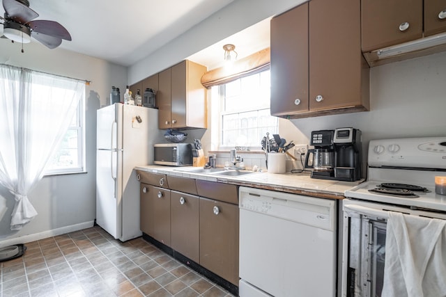 kitchen with ceiling fan, tile countertops, sink, and white appliances