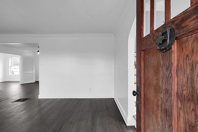 interior space featuring dark hardwood / wood-style flooring, ceiling fan, and ornamental molding