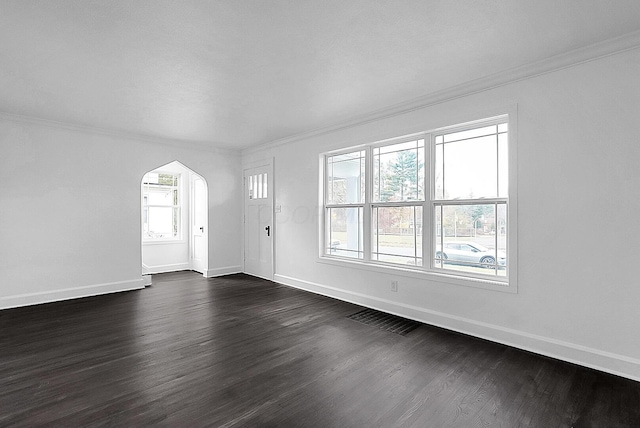 unfurnished living room with crown molding and dark wood-type flooring