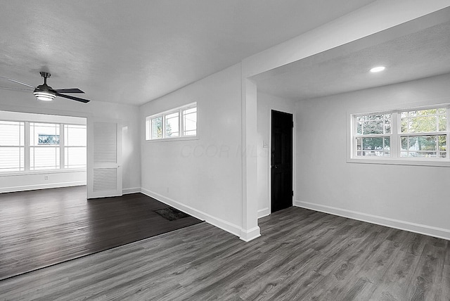 unfurnished room with a textured ceiling, dark hardwood / wood-style floors, and ceiling fan