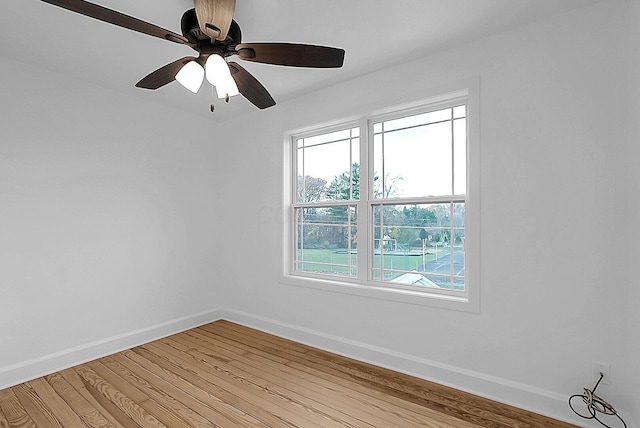 empty room with ceiling fan, plenty of natural light, and light hardwood / wood-style floors