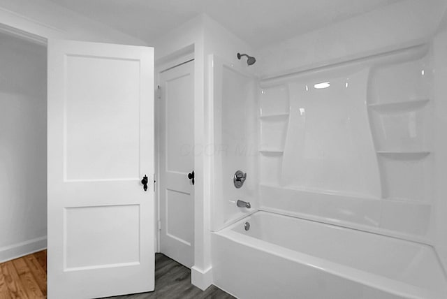 bathroom featuring hardwood / wood-style floors and tub / shower combination