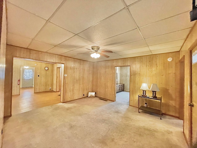 unfurnished room featuring a wealth of natural light, a paneled ceiling, and ceiling fan