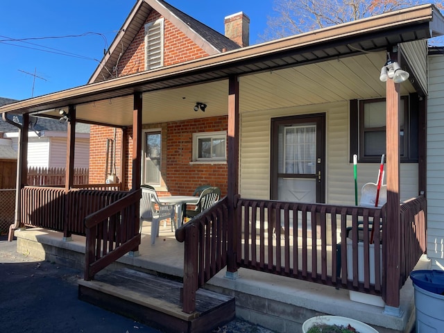 view of exterior entry with covered porch