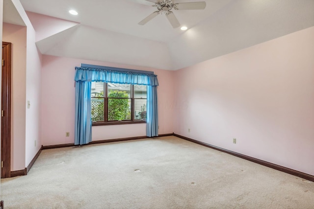 carpeted empty room with ceiling fan and lofted ceiling