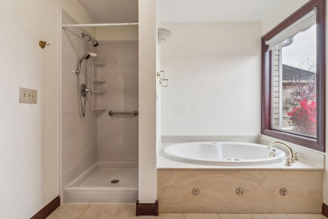 bathroom featuring tile patterned floors and independent shower and bath