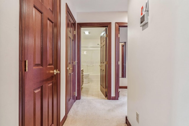 hallway featuring light carpet