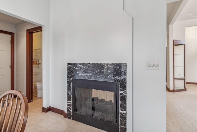 interior details featuring a fireplace and carpet