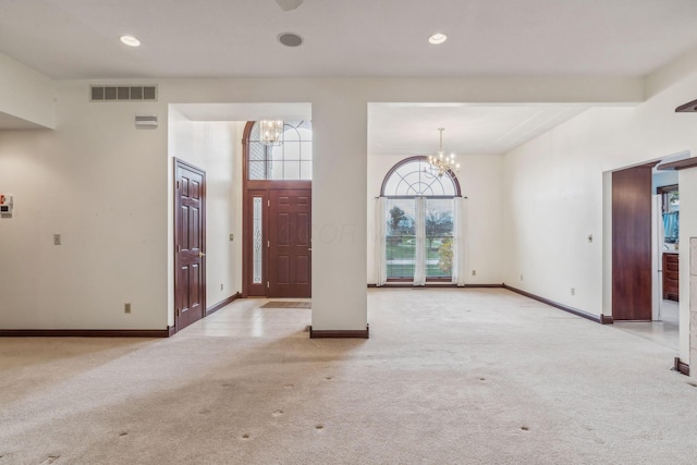 carpeted entryway featuring a chandelier and beamed ceiling