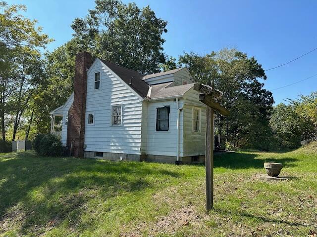 view of side of home featuring a yard