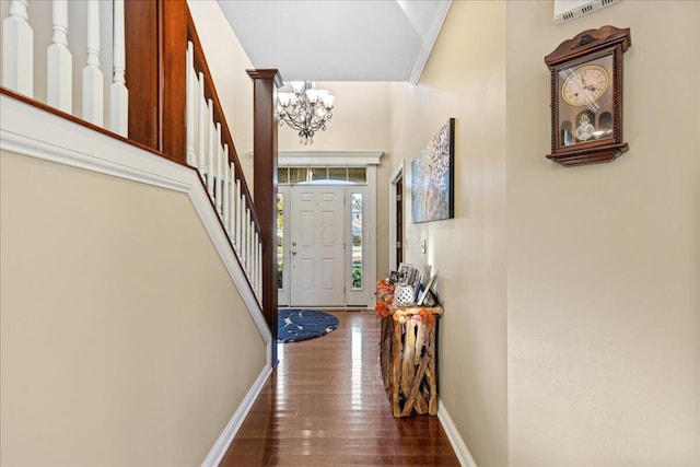 foyer entrance with a chandelier and dark hardwood / wood-style floors