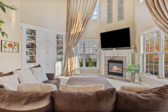 living room featuring built in features and a towering ceiling