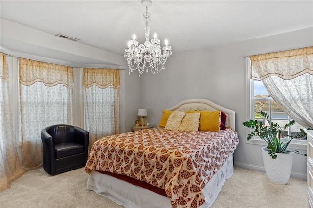 carpeted bedroom with an inviting chandelier