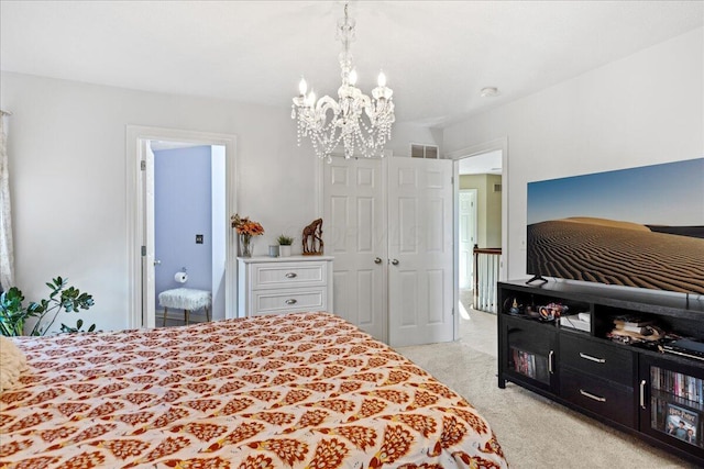 bedroom with a chandelier, a closet, and light colored carpet