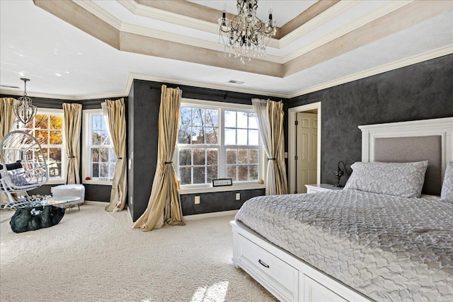 bedroom with ornamental molding, a tray ceiling, and multiple windows