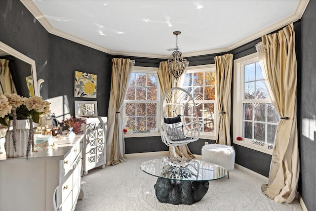 sitting room featuring a chandelier, light colored carpet, crown molding, and a healthy amount of sunlight