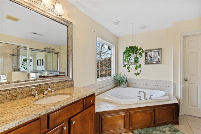 bathroom featuring tile patterned flooring, vanity, and shower with separate bathtub