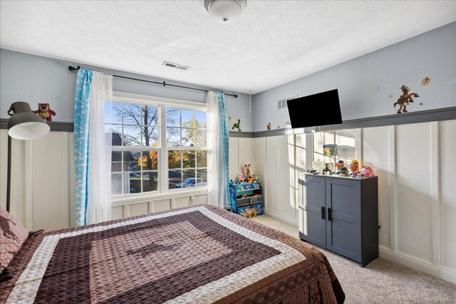 carpeted bedroom with a textured ceiling