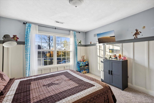 carpeted bedroom featuring a textured ceiling