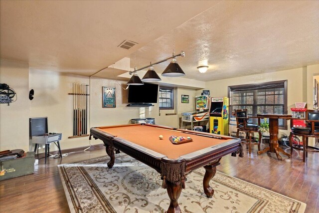 recreation room with hardwood / wood-style floors, a textured ceiling, and pool table