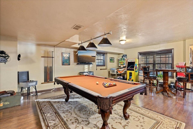 game room featuring wood-type flooring, a textured ceiling, and billiards