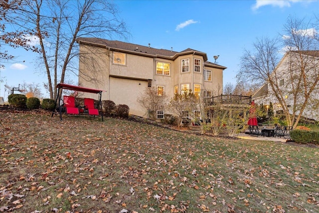 rear view of property featuring a lawn and a patio area