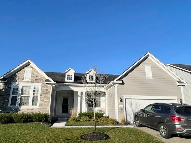 view of front of home featuring a garage and a front yard