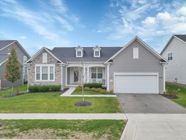 view of front of property featuring a garage and a front yard