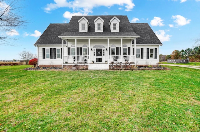 back of property with a yard and a porch