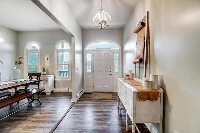 entrance foyer featuring dark hardwood / wood-style flooring, an inviting chandelier, and baseboard heating