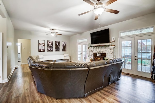 living room with french doors, ceiling fan, a healthy amount of sunlight, and wood-type flooring