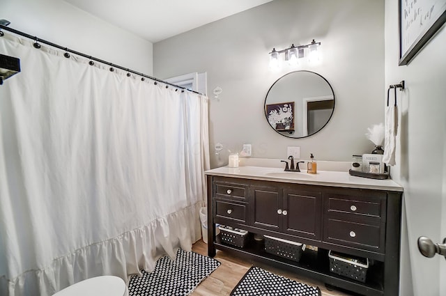 bathroom featuring hardwood / wood-style floors, vanity, and toilet