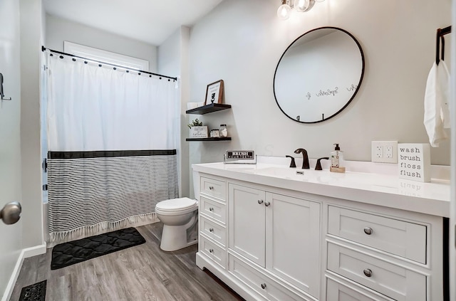 bathroom featuring hardwood / wood-style floors, vanity, and toilet