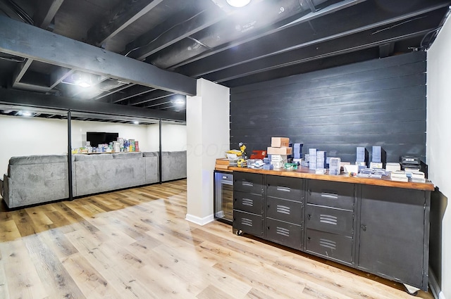 bar with wooden counters, light hardwood / wood-style floors, and wine cooler