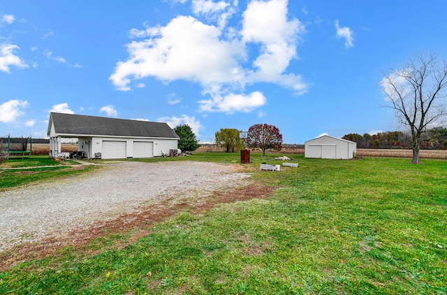 view of yard featuring an outbuilding and a garage