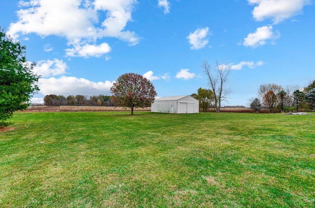 view of yard featuring a rural view and an outdoor structure