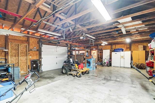 garage featuring white fridge with ice dispenser