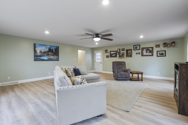 living room with ceiling fan and light wood-type flooring