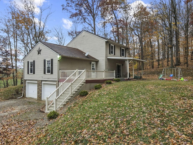 view of side of home with a garage, a lawn, and a porch